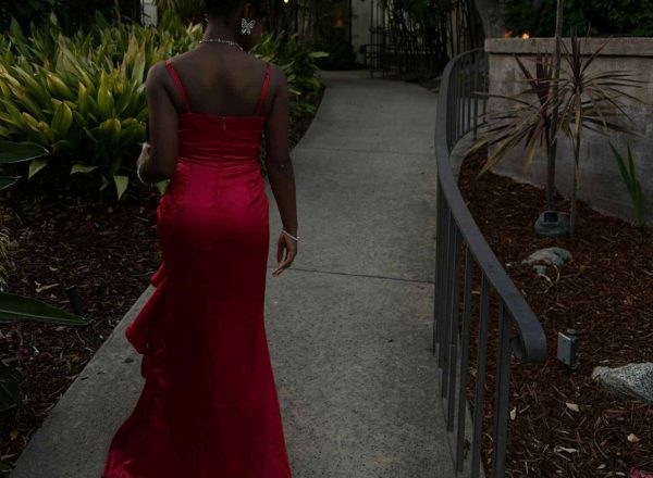 Model showing the back of a red satin dress